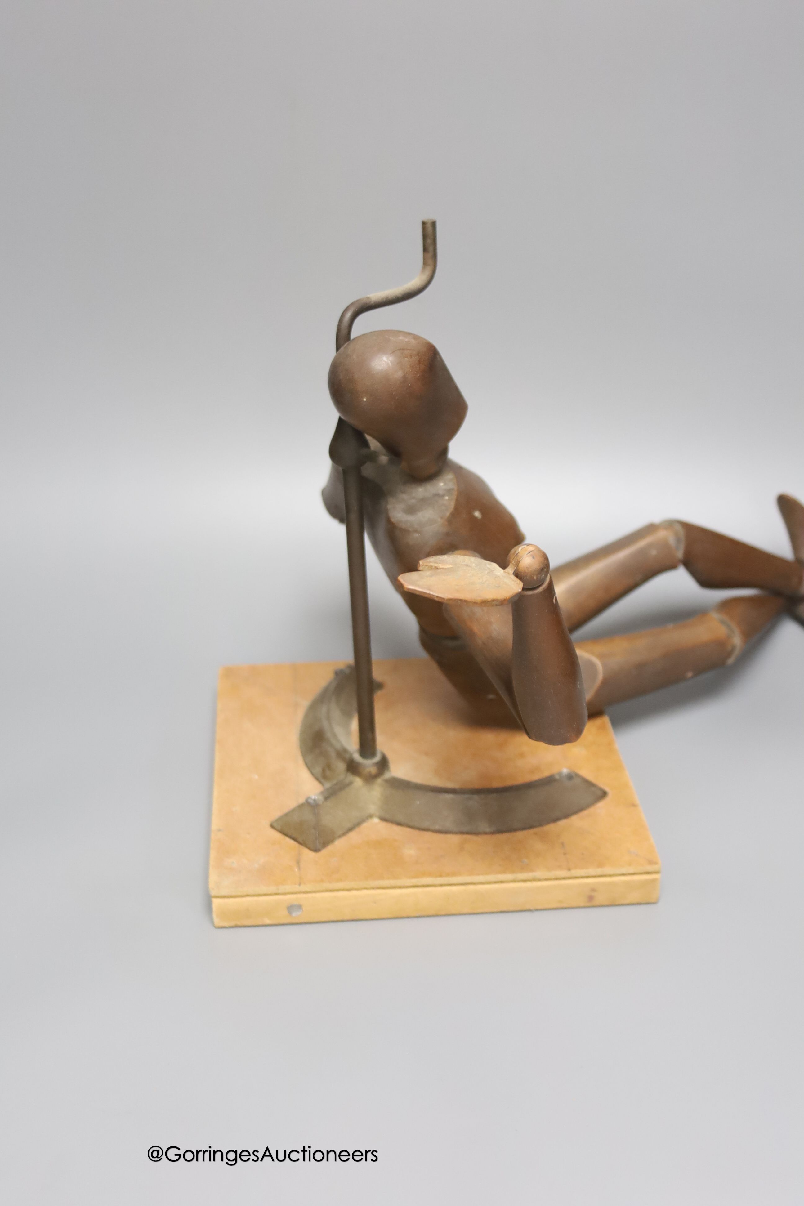 A late 19th century carved beech lay figure, on cast metal stand, height 38cm